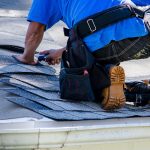 Guy installing asphalt shingles