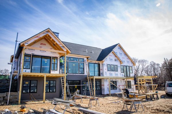a new build with wood cladding and a new shingle roof