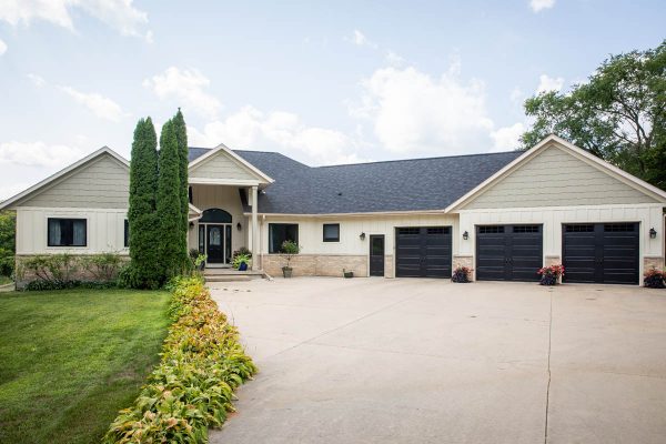 a large, gran home with new shingle roofing