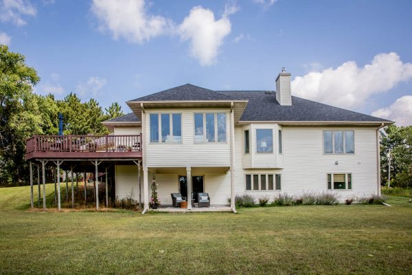 large detached home with balcony decking and a new roof