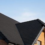 A modern home with a clean grey roof made of durable, weather-resistant shingles, illustrating tips on extending the life of your roof