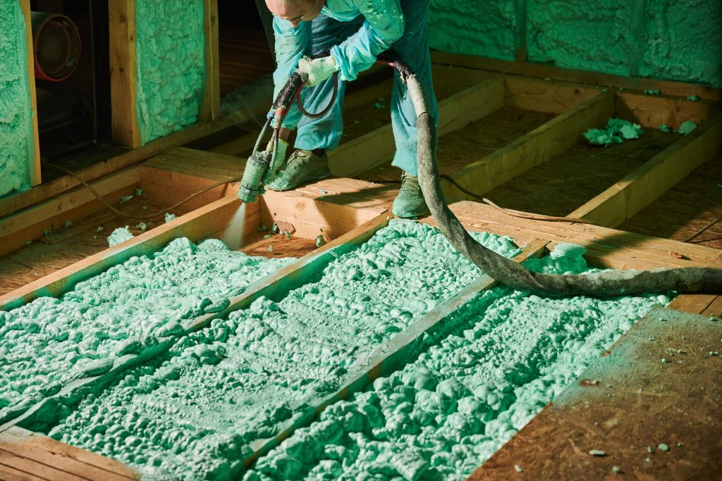 man spraying foam insulation