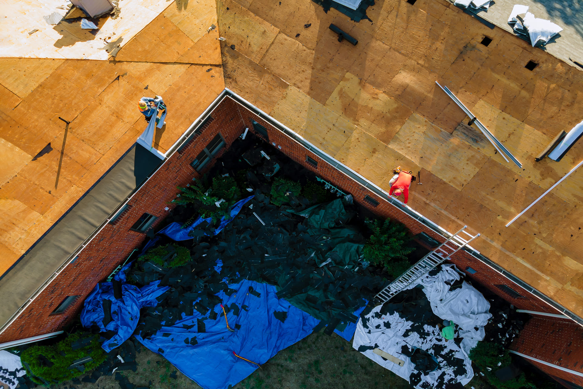 aerial-view-of-workers-repairing-large-roof-section