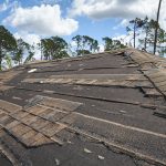 close-up-of-damaged-roof-with-missing-shingles