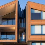 contemporary-apartment-building-with-wood-panel-facade-and-glass-balconies
