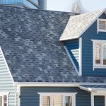 blue-gray-asphalt-shingle-roof-on-suburban-home-with-dormer-and-white-trim