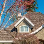 stucco-home-with-cedar-shake-roof-and-arched-dormer-window