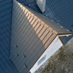aerial-view-of-dark-blue-metal-tile-roof-with-brown-ridge-caps